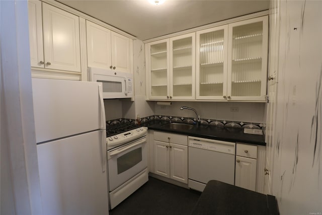 kitchen featuring white appliances, white cabinetry, and sink