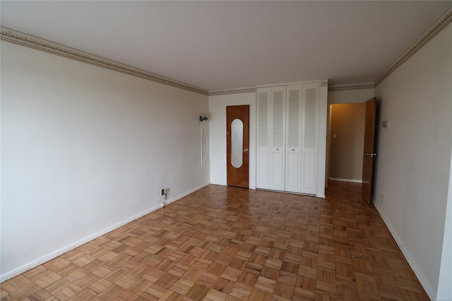 unfurnished bedroom with parquet floors and crown molding