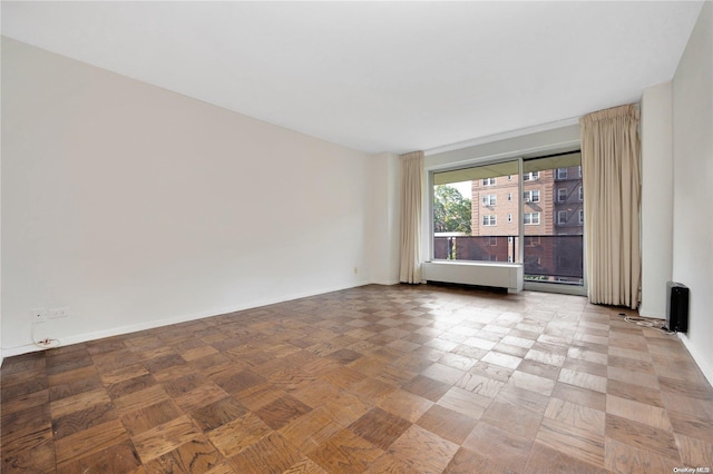 110-11 Queens Blvd Unit F4, Forest Hills, NY 11375 - empty room featuring baseboards and radiator heating unit