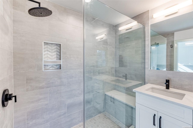 bathroom featuring vanity and a tile shower