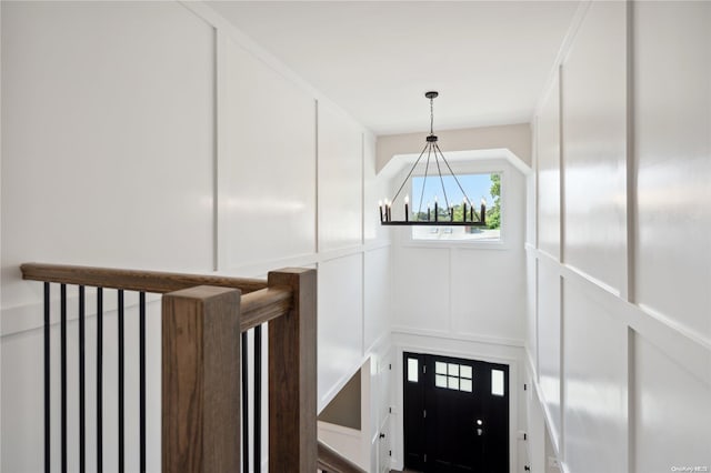 stairs with a chandelier