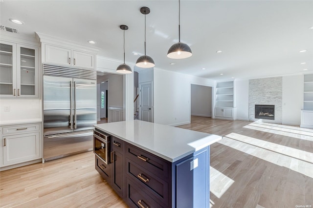 80 Ocean Ave, Massapequa, NY 11758 - kitchen with stainless steel built in refrigerator, light wood finished floors, visible vents, and light countertops