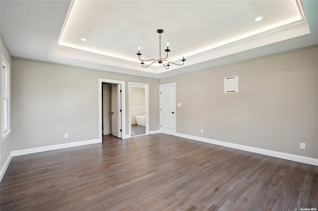 80 Ocean Ave, Massapequa, NY 11758 - empty room featuring an inviting chandelier, a tray ceiling, dark wood-style floors, and baseboards
