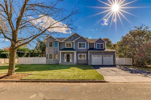 80 Ocean Ave, Massapequa, NY 11758 - view of front facade featuring stone siding, fence, aphalt driveway, and a front yard