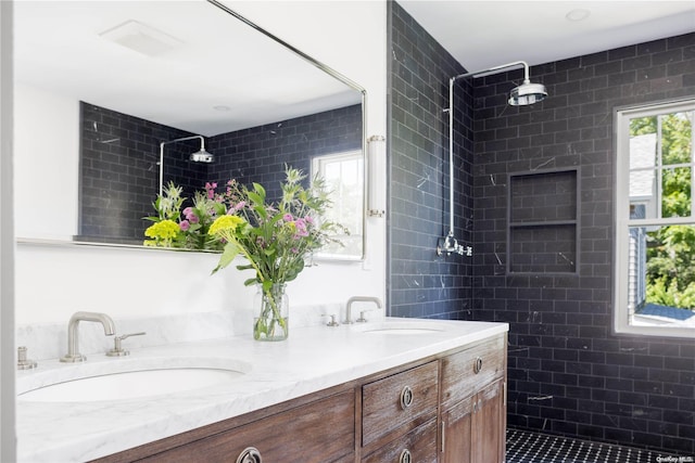 bathroom with vanity and a tile shower