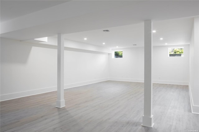 basement with hardwood / wood-style floors and a wealth of natural light