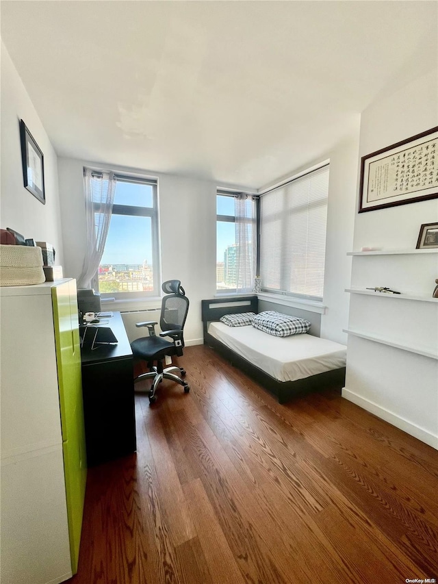 bedroom with dark hardwood / wood-style floors