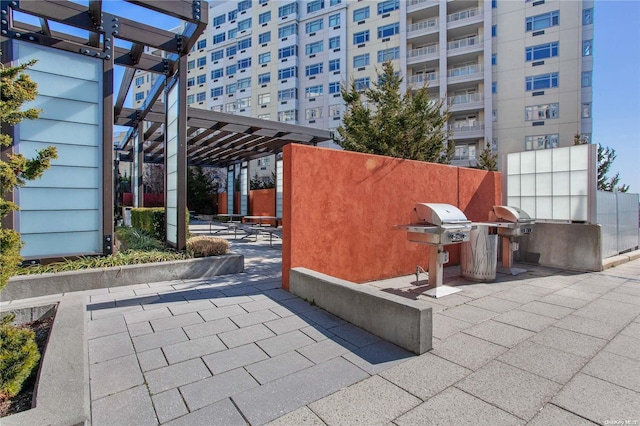 view of patio with a pergola and area for grilling