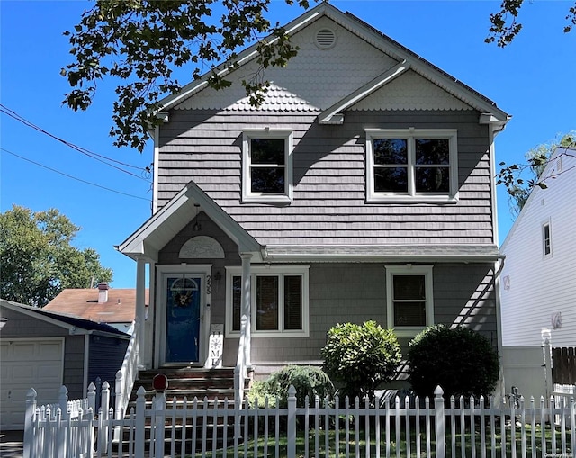 view of front facade featuring a garage and an outdoor structure