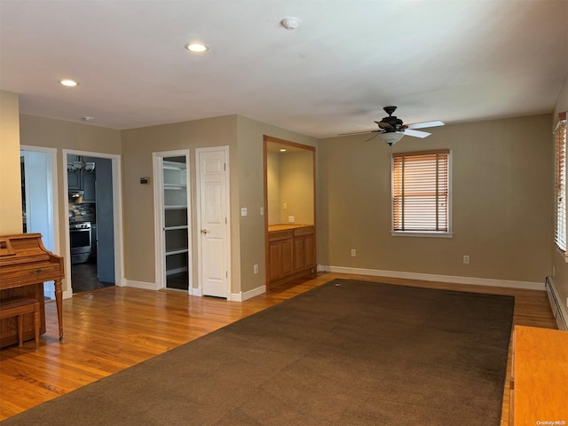 unfurnished living room featuring ceiling fan and light hardwood / wood-style flooring