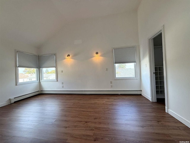 spare room with dark hardwood / wood-style flooring, vaulted ceiling, and a healthy amount of sunlight