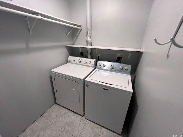 clothes washing area with washing machine and dryer