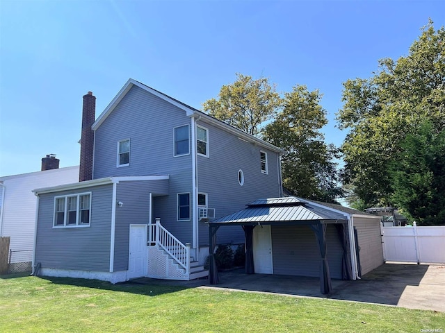 back of house with a lawn