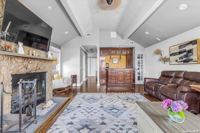 living room featuring a fireplace, lofted ceiling with beams, ceiling fan, and dark wood-type flooring