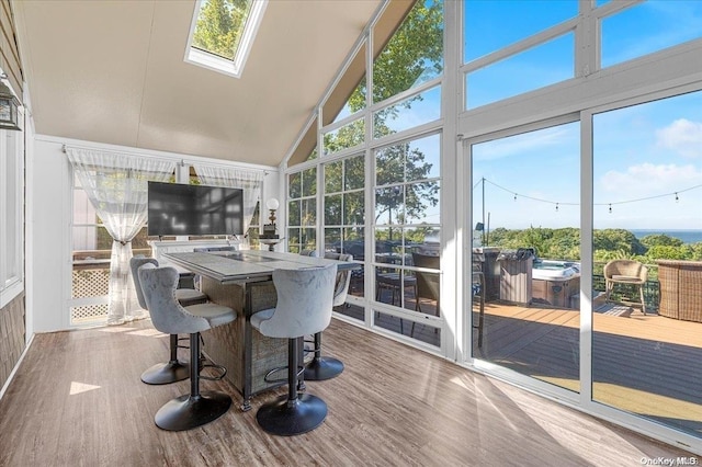 sunroom featuring a wealth of natural light and lofted ceiling