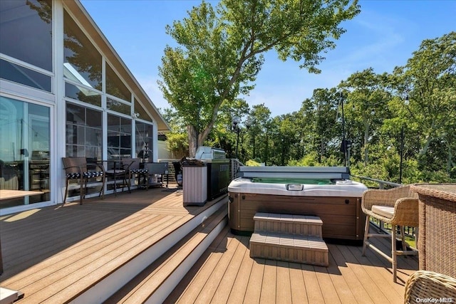 wooden terrace with a hot tub