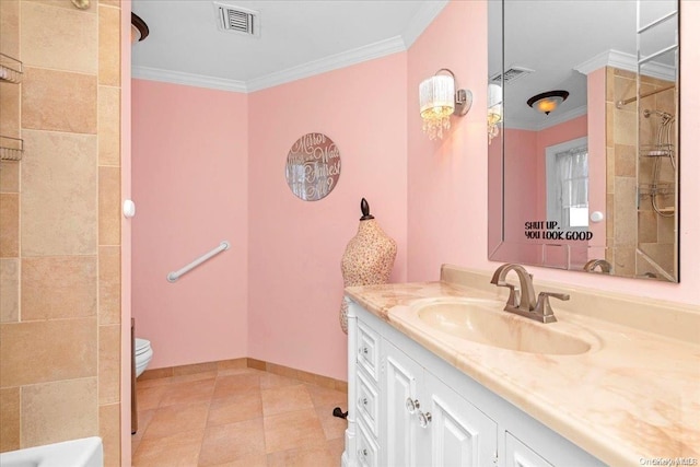 bathroom featuring tile patterned flooring, vanity, toilet, and crown molding