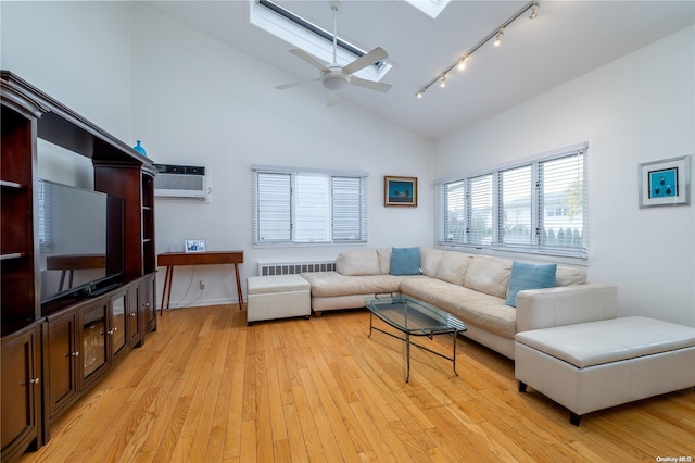 living room featuring high vaulted ceiling, light hardwood / wood-style flooring, ceiling fan, and an AC wall unit