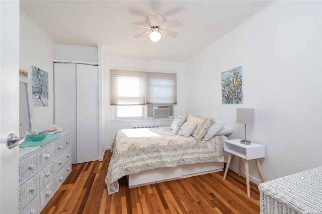 bedroom with cooling unit, crown molding, ceiling fan, and dark wood-type flooring