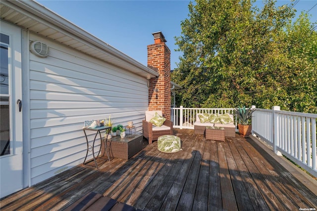 wooden terrace featuring an outdoor hangout area