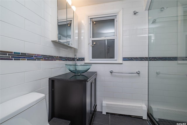 bathroom featuring vanity, tile walls, and a baseboard heating unit