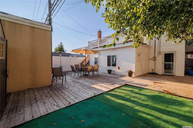 back of house featuring a yard and a deck