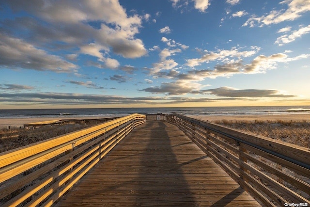 view of property's community with a beach view and a water view