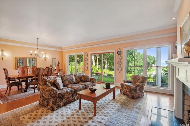 156 Ram Island Dr, Shelter Island, NY 11964 - living room featuring a fireplace, a chandelier, wood finished floors, and crown molding