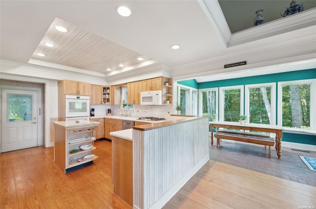 156 Ram Island Dr, Shelter Island, NY 11964 - kitchen with open shelves, stainless steel appliances, a raised ceiling, ornamental molding, and light wood finished floors