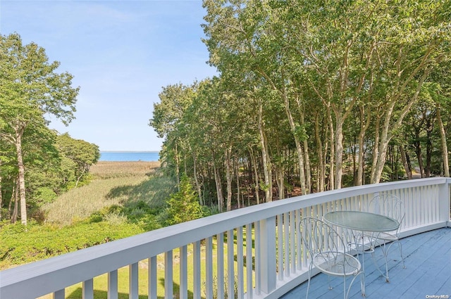 wooden terrace featuring a water view