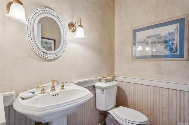 156 Ram Island Dr, Shelter Island, NY 11964 - half bathroom with a sink and a wainscoted wall