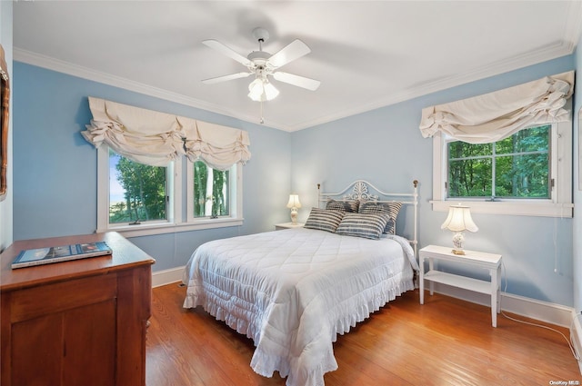 156 Ram Island Dr, Shelter Island, NY 11964 - bedroom with multiple windows, wood finished floors, ornamental molding, and ceiling fan