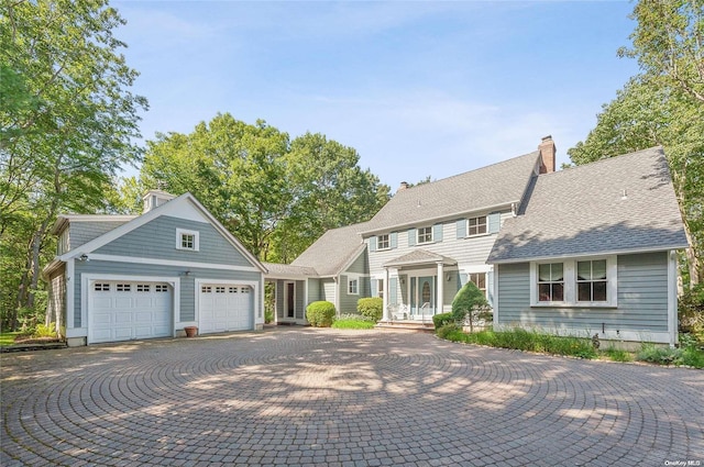156 Ram Island Dr, Shelter Island, NY 11964 - view of front of house featuring an attached garage, driveway, and a chimney
