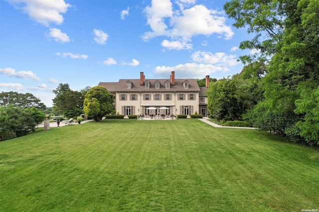 back of house with french doors, a yard, and a patio area