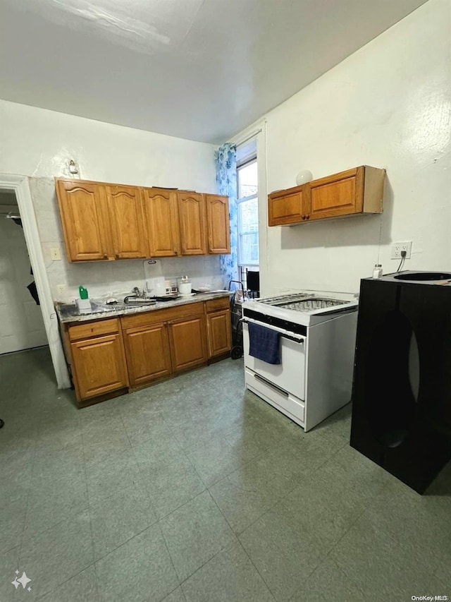 kitchen with washer / clothes dryer and white range