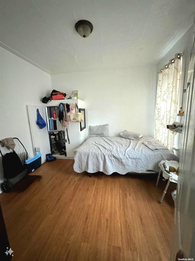 bedroom with hardwood / wood-style flooring