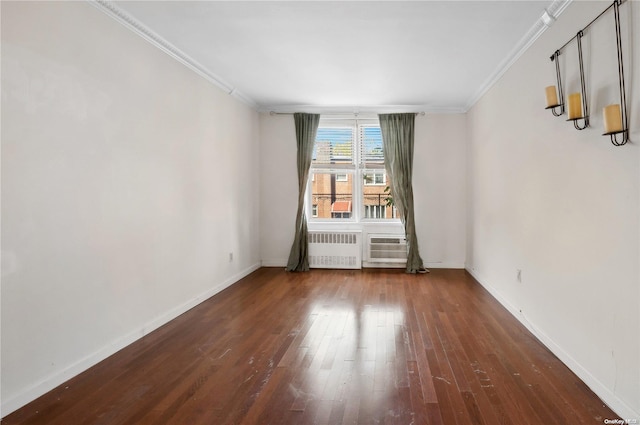 unfurnished room featuring dark hardwood / wood-style floors, radiator, and ornamental molding