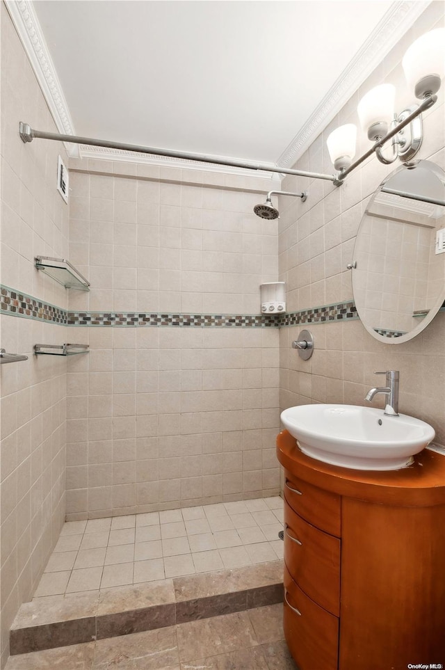 bathroom featuring crown molding, vanity, and tile walls