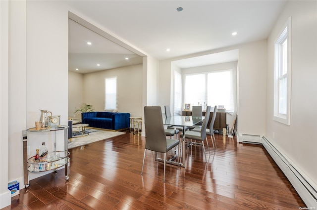 dining room with hardwood / wood-style floors and a baseboard heating unit