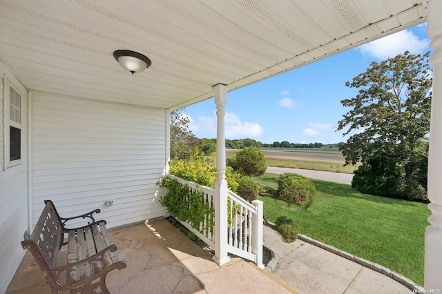 view of patio featuring a porch and a rural view