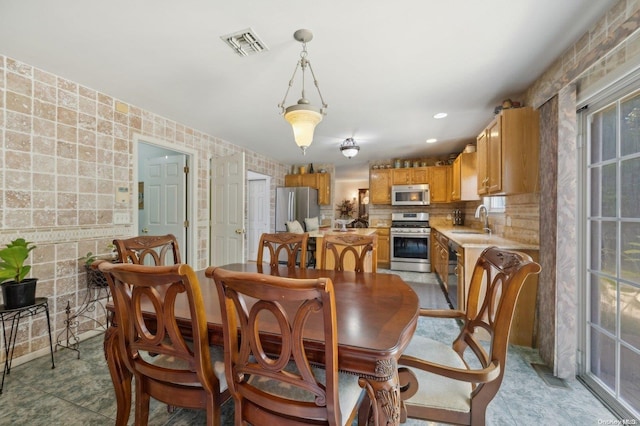 dining area with sink and light tile patterned flooring