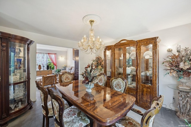 dining room with dark carpet and an inviting chandelier