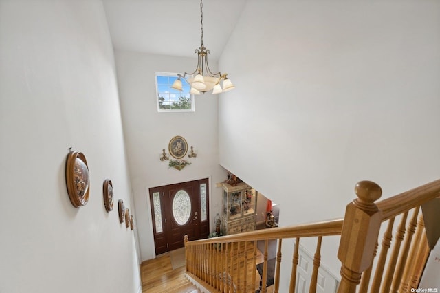 foyer with an inviting chandelier and light hardwood / wood-style flooring