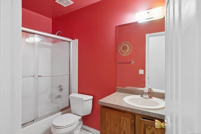 full bathroom with vanity, enclosed tub / shower combo, and toilet