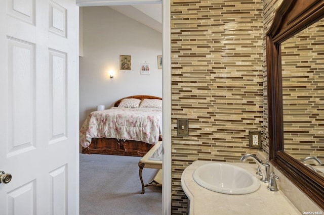 bathroom with decorative backsplash and sink