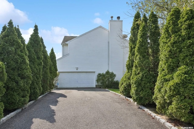 view of side of home featuring a garage