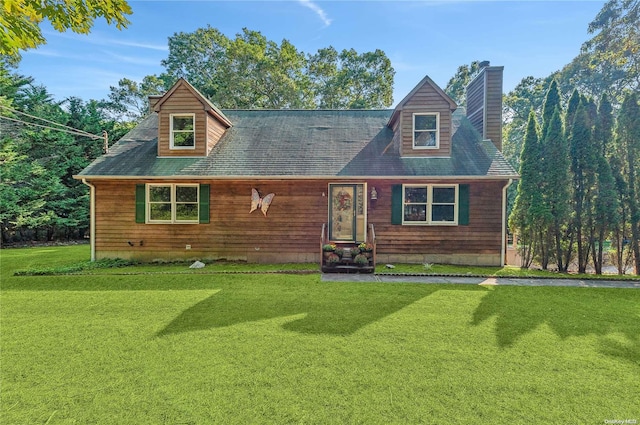 cape cod house featuring a front yard