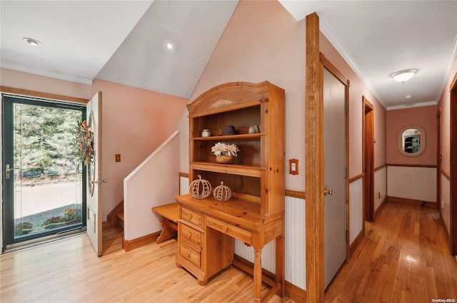 hall featuring lofted ceiling, light hardwood / wood-style floors, radiator, and crown molding