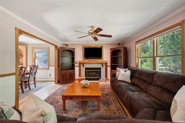 living room with ceiling fan and ornamental molding