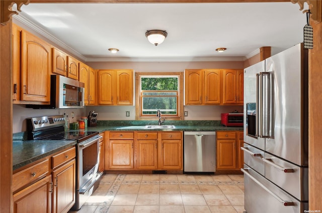 kitchen featuring light tile patterned floors, stainless steel appliances, crown molding, and sink